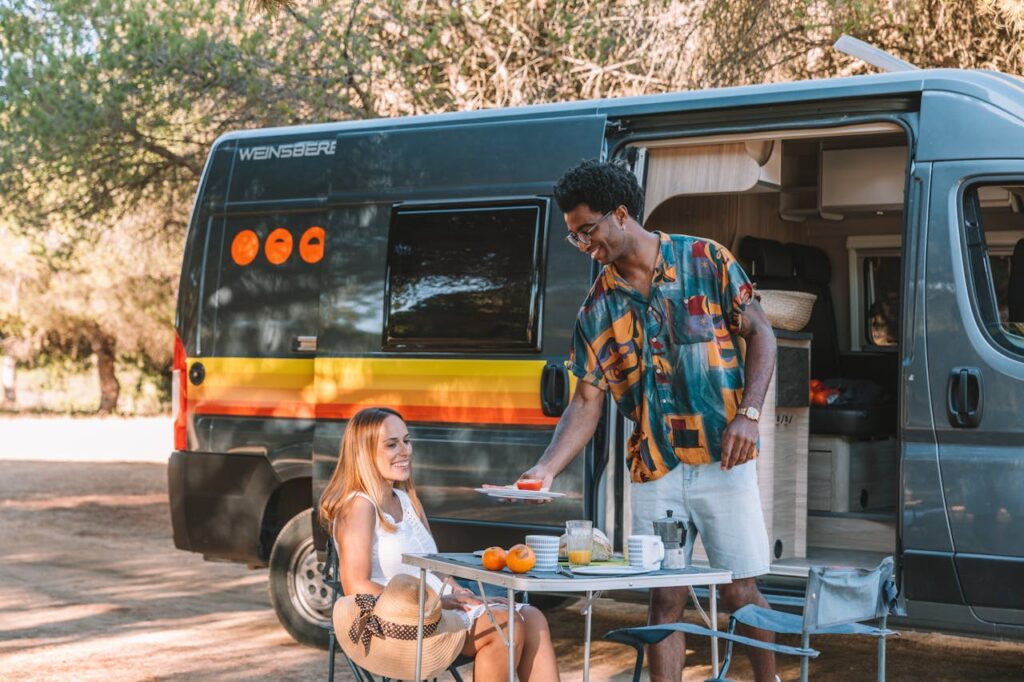Van life couple cooking dinner outside